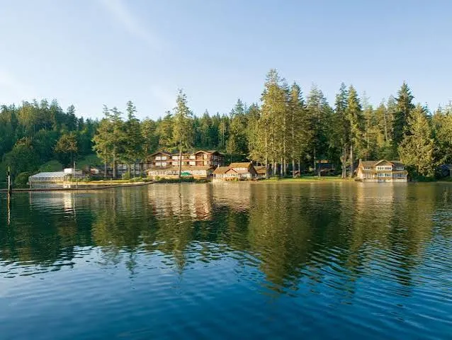 Alderbrook Resort reflected in calm Hood Canal water at golden hour