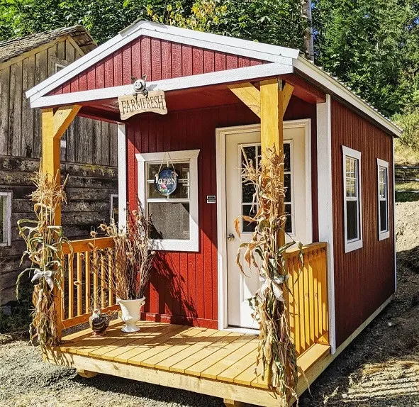 Red Hungry Hollow farmstand with a wooden porch near Belfair, WA